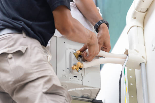 istock Young repairman fixing air conditioner unit, Asian technician man installing an air conditioning in a client house, Maintenance and repairing concepts 2155232875