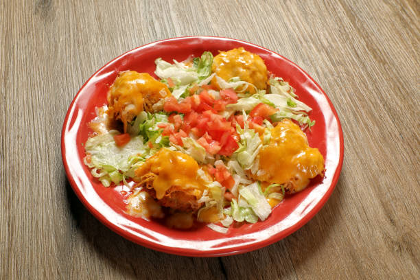 istock Chicken and cheese Mexican dish on wooden table 2155233185