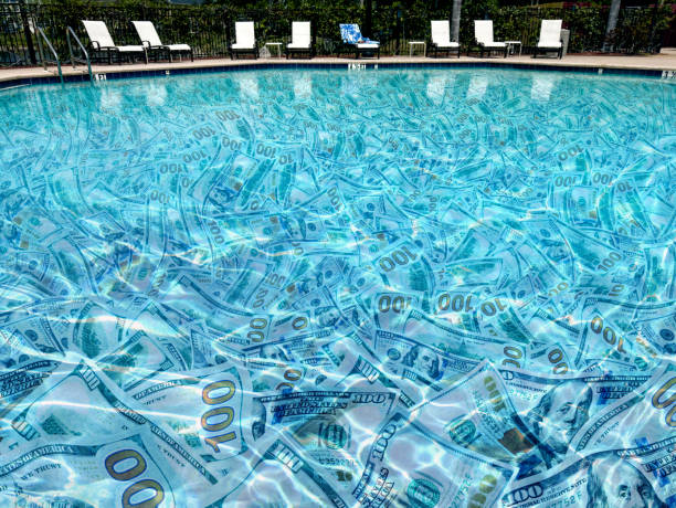 Conceptual large group of American one hundred dollar bills underwater