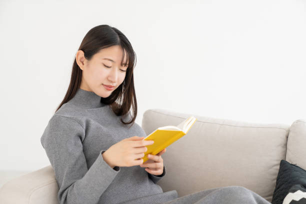 istock asian woman who reads a book, 2155233371