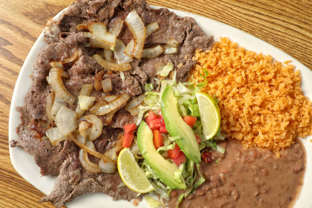 istock Mexican steak dish Carne Asada on wooden table 2155233942