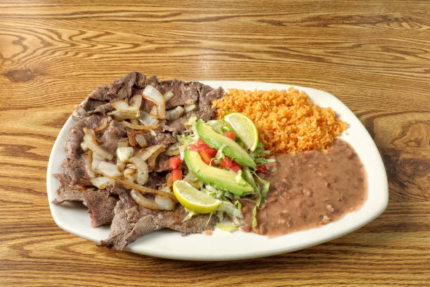 istock Mexican steak dish Carne Asada on wooden table 2155233984