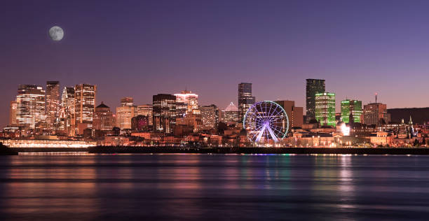 Montreal skyline at night reflected in St. Lawrence River, Quebec, Canada