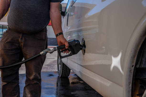 istock Hand Refilling the Car with Fuel at the Refuel Station 2155236081