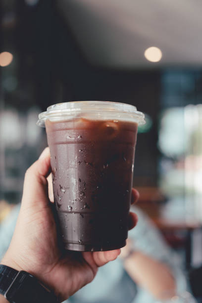 istock Man hand holding a take-out iced americano 2155237121