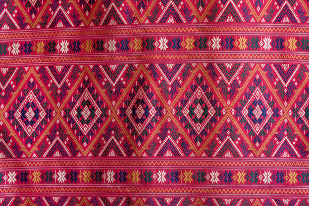 Beautiful seamless Thai pattern Ethnic geometric fabric pattern, embroidered cross stitch, oriental pixel pattern. Brown background, abstract, vector, illustration. Texture, clothing, scarf, decoration, pattern, silk wallpaper.