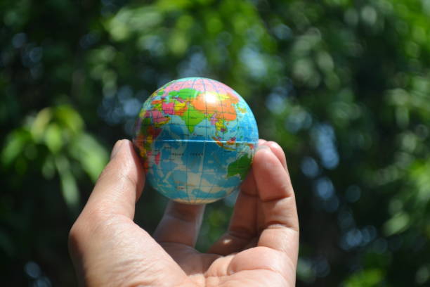istock Human Hand Holding a Earth Globe for Protecting Planet in World Earth Day Concept. 2155239421