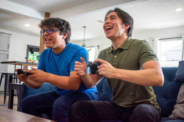 istock Two brothers play video games at home 2155239723