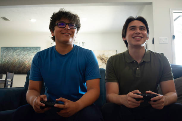 istock Two brothers play video games at home 2155239724