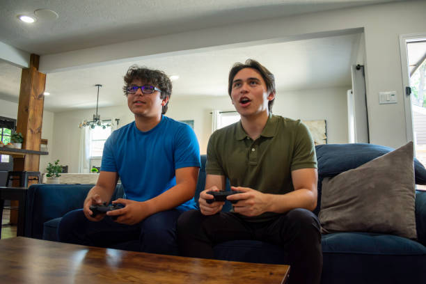 istock Two brothers play video games at home 2155239725