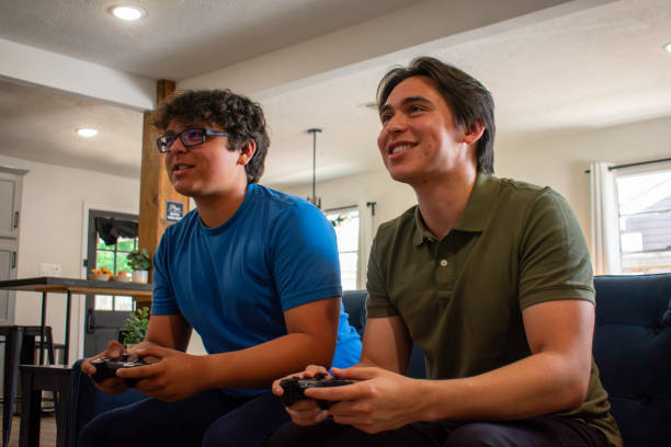 istock Two brothers play video games at home 2155239729