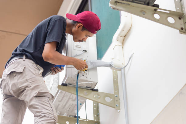 istock Repairman fixing air conditioner unit, Asian technician man installing an air conditioning in a client house, Maintenance and repairing concepts 2155240424
