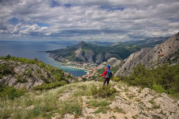 istock Senior woman hiking on the mountain 2155241614