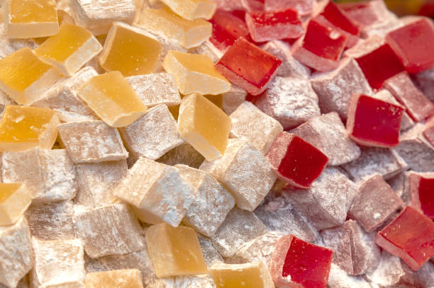 istock Turkish delight sweet cubes background. Lokum sprinkled with sugar. Top view 2155241912