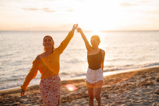 istock Cheerful female friends at beach party 2155244862