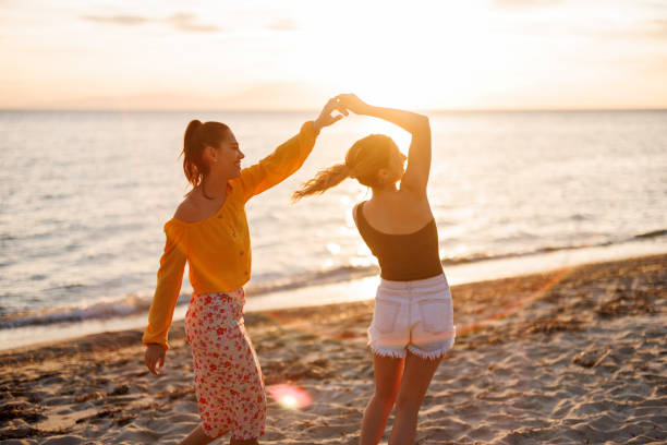 istock Cheerful female friends at beach party 2155244936