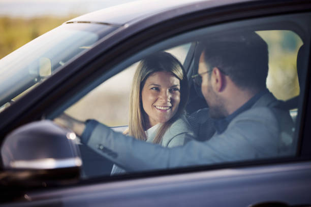 istock Happy business couple talking while traveling by car. 2155247625
