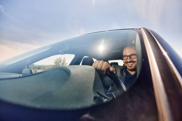 istock Happy male entrepreneur going on business trip by car. 2155247654