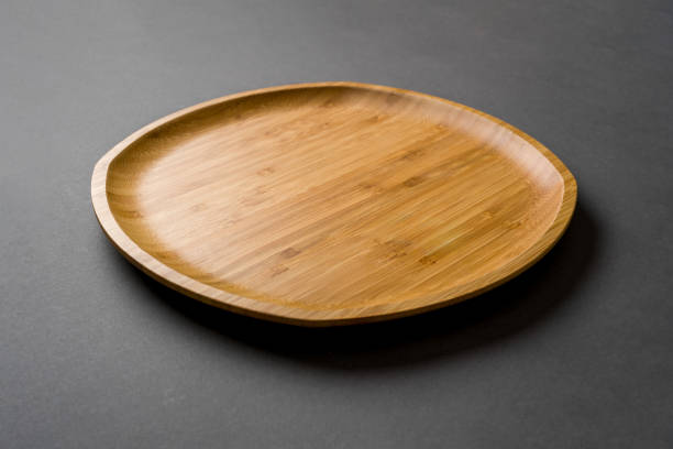 istock Wooden plate on dark gray background. handmade kitchen utensils 2155248958