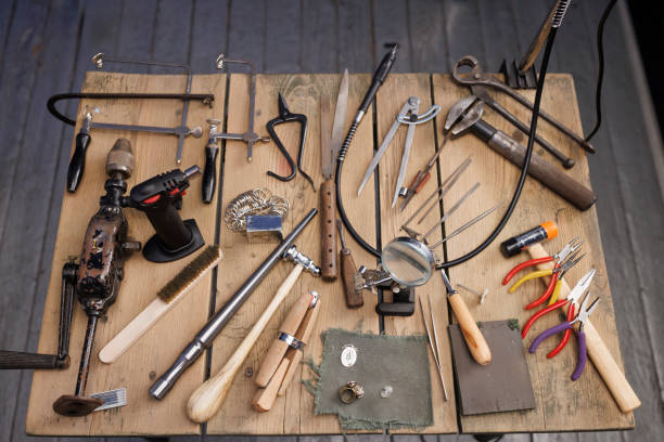 istock Jeweler workshop   Vintage and modern jeweler tools on rustic wooden table 2155250181
