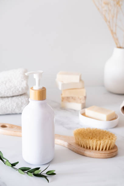 istock White cosmetic bottle with eucalyptus leaves on the background of bath accessories 2155252500