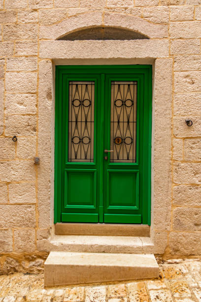 istock Green door in an old stone building 2155253561