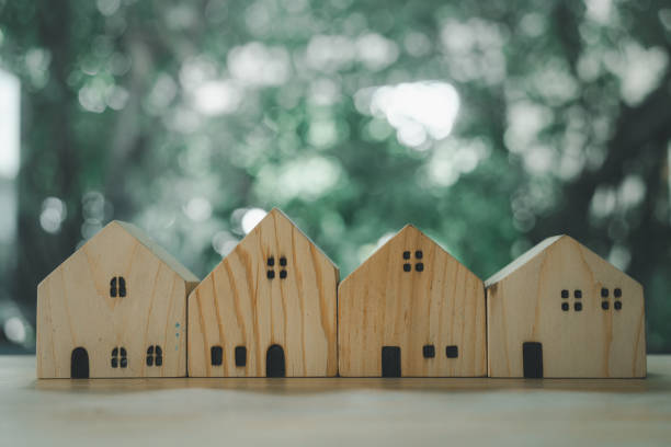 istock A different wood house model against nature background 2155254050