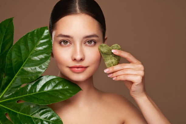 istock Close up woman face with green exotic leaf 2155254908