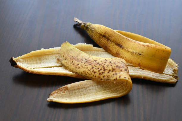 Rotten banana peel on wood table.