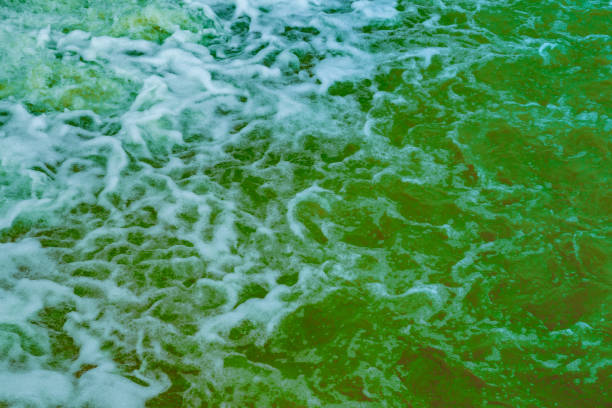 Miniature macro wave breaking on shoreline with stunning detail. Abstract ocean theme.