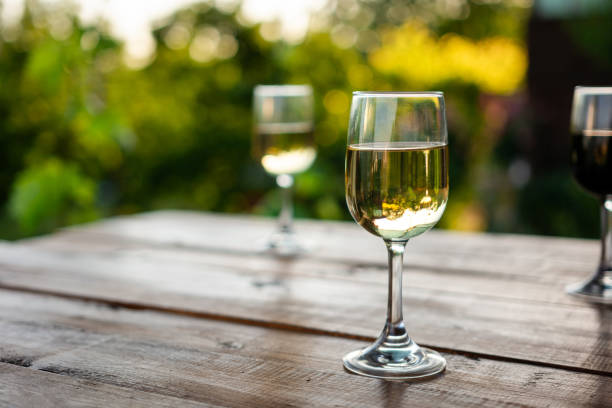 istock White and red wine glasses on wooden table 2155257930