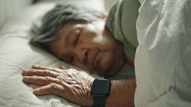 istock Elderly woman wear a smart watch while sleeping. 2155258654