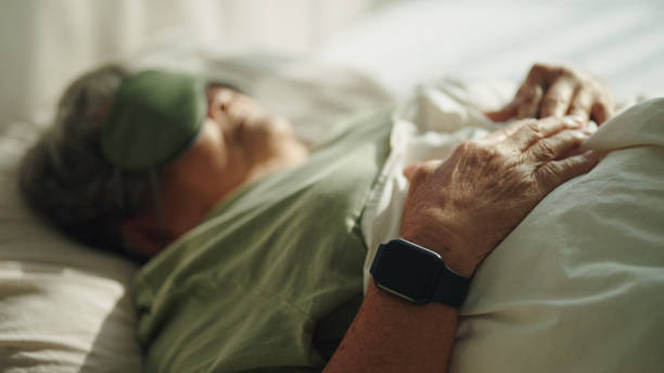 istock Elderly woman wear a smart watch while sleeping. 2155258655