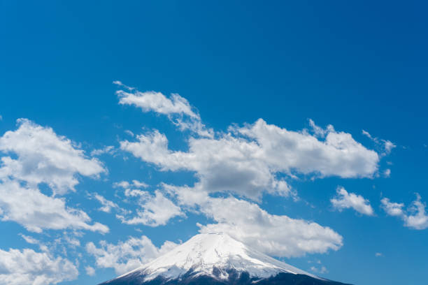 Mt. Fuji in early summer where cumulus clouds cast shadows