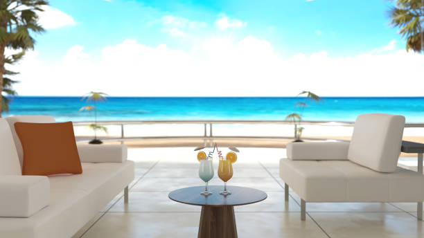 istock Cocktail Glasses on the Table in a Luxurious Modern Room Overlooking a Serene Tropical Beach 2155263015