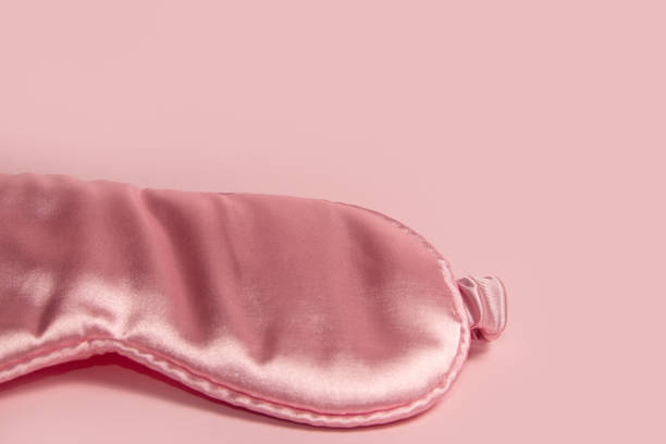 istock Pink silk sleeping mask on a pastel pink background 2155264286