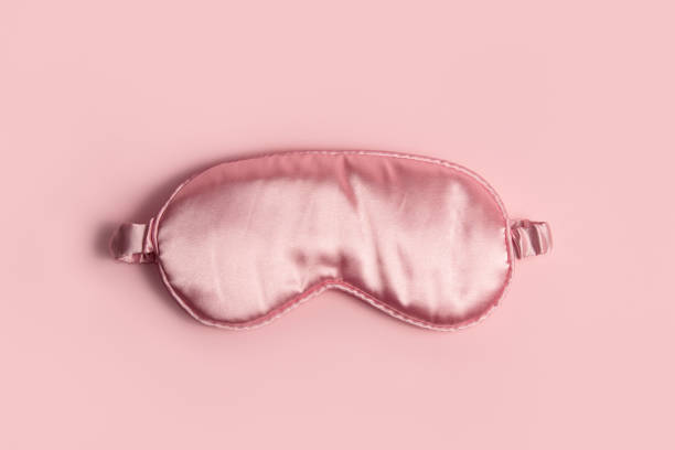 istock Pink silk sleeping mask on a pastel pink background 2155265000
