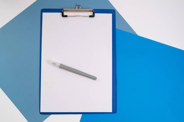 istock Blank tablet with a white sheet and a pen on a light background. A4 holder. Stationery. Blank document holder with space for text. Mockup 2155268965