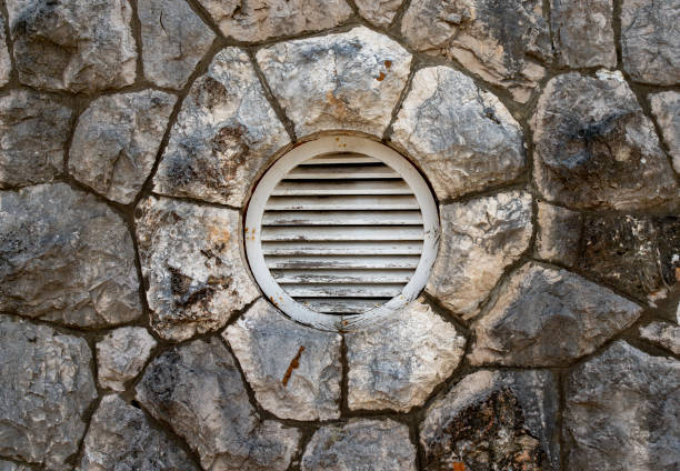 Weathered slatted vent on a stone wall in Kolocep, Croatia.