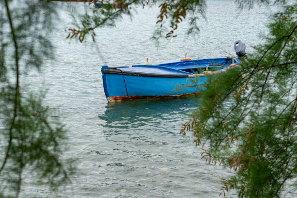 The harbour at Kolocep Island, Croatia.  In the foreground is a rowing boat moored in the harbour.