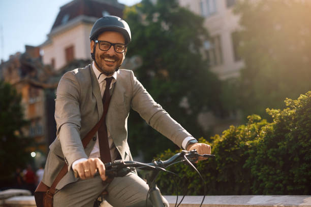 istock Happy businessman commuting to work by bicycle and looking at camera. 2155271435