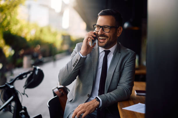 istock Happy businessman talking on cell phone in a cafe and looking away. 2155272081