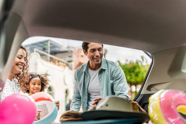 istock Family unloading luggages from the car trunk 2155274876