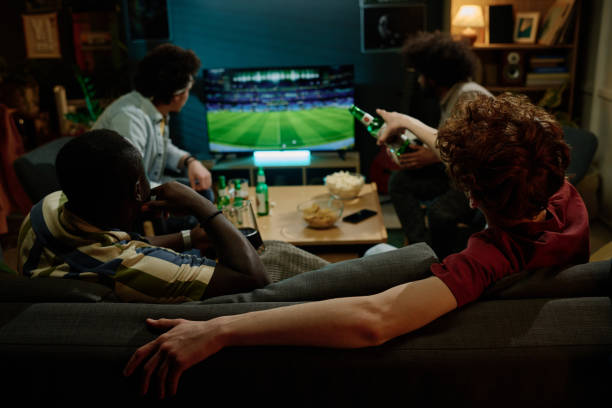 istock Young Men Watching Soccer Game On TV 2155275370