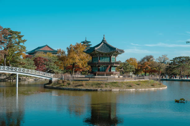 Experience the tranquil charm of Hyangwonjeong Pavilion nestled in Gyeongbokgung Palace, Seoul, South Korea, on a picturesque day. The pavilion is an historic gem.