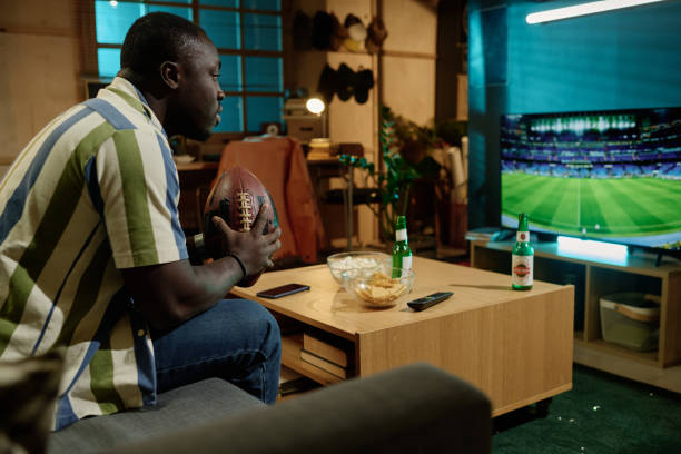 istock Black Football Fan Watching Match 2155276514