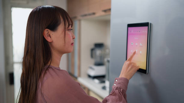 istock Asian woman checking smart fridge screen for ingredients in kitchen 2155276592