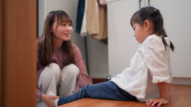 istock Mother helping her small daughter tying her shoes 2155277076