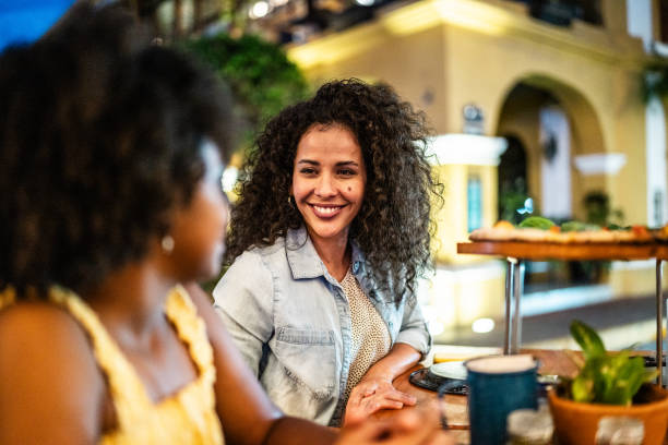 istock Mother talking with daughter during dinner at outdoors restaurant 2155277277
