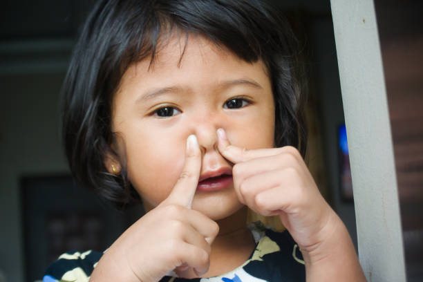 istock Toddler girl covering her nose 2155281173